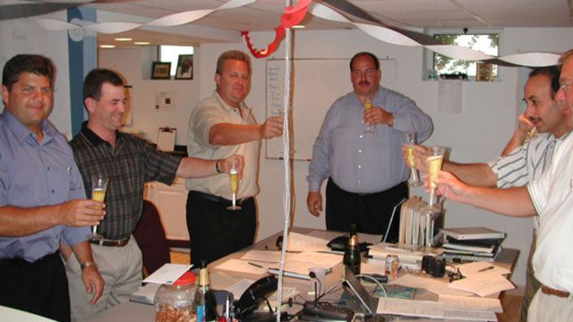 Convergint colleagues toasting to success in office header image