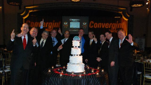 Celebrating group photo around a cake header image