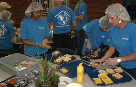 Convergint day Ottawa colleagues preparing sandwiches for lunch
