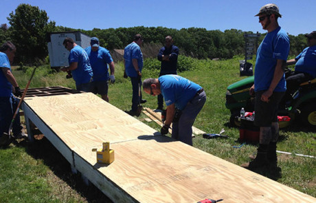 Convergint Day New York colleagues building a wood ramp