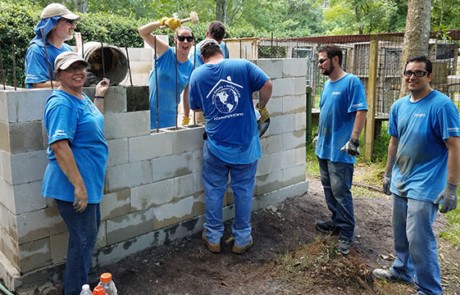 Convergint day Jacksonville Colleagues working on a brick wall