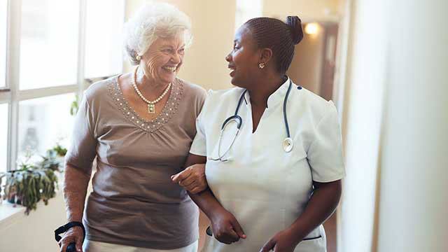 Nurse assisting senior women header image