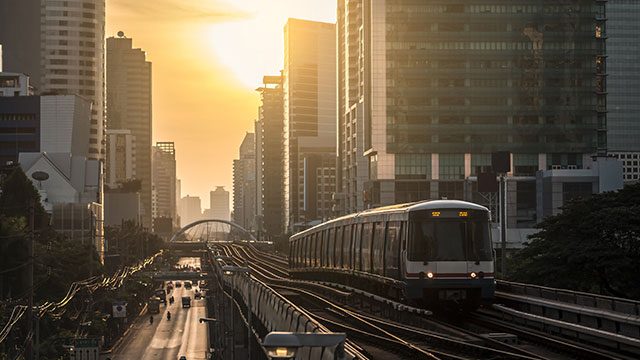 Train moving through sunset across skyline header image