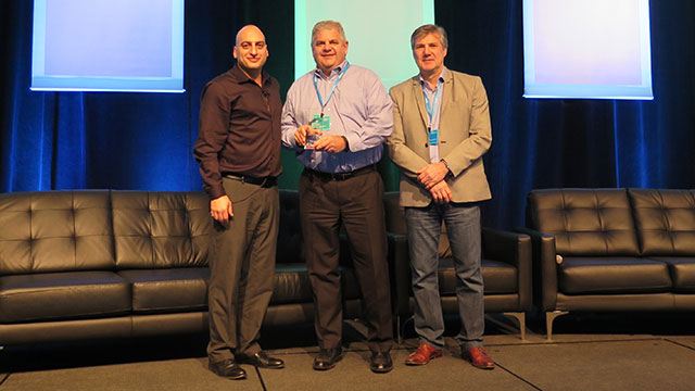 Tony Varco receiving award on stage for Genetec NA account of the year header image
