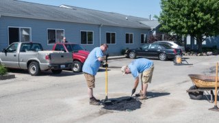 Convergint day colleagues fixing a pothole