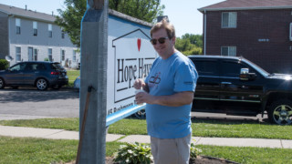 Convergint day Colleague painting front sign