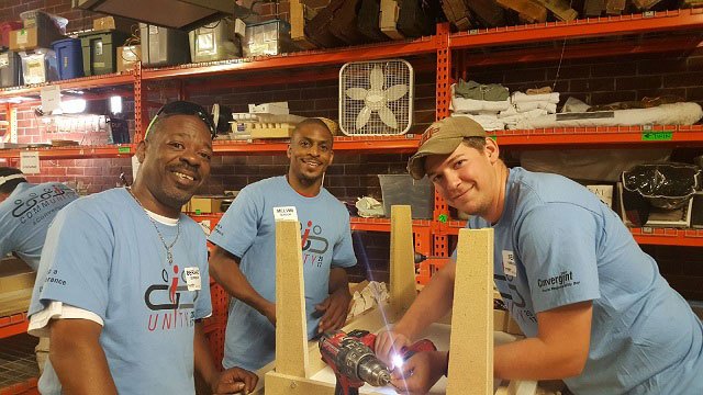 Convergint day colleagues building a table