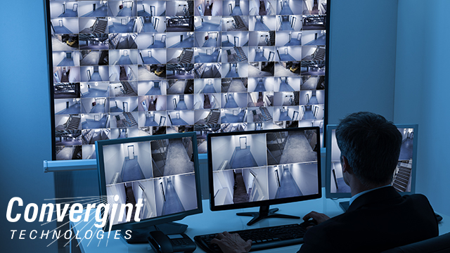 Guy sitting at desk looking at cameras