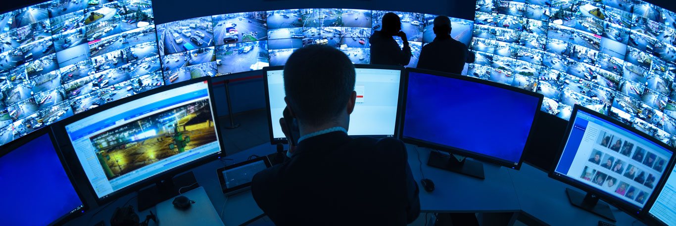 Video-Security-wall Man sitting in front of a video security wall
