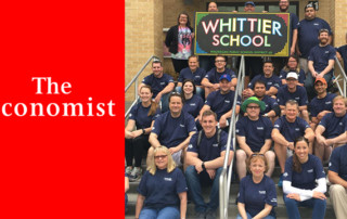 Convergint Colleagues Sit on the Steps of a School At Which They Volunteered