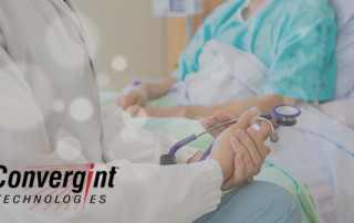 Doctor sitting bedside with patients
