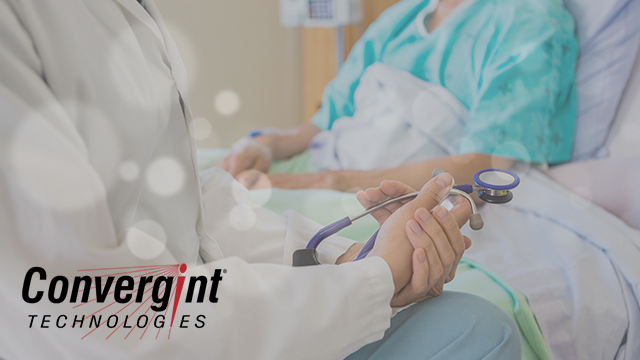 Doctor sitting bedside with patients