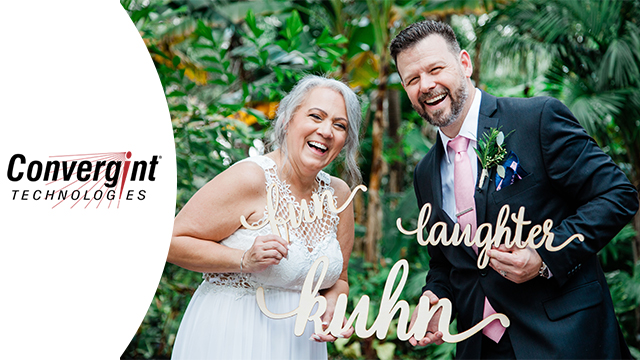 Bride and groom pose with word cutouts