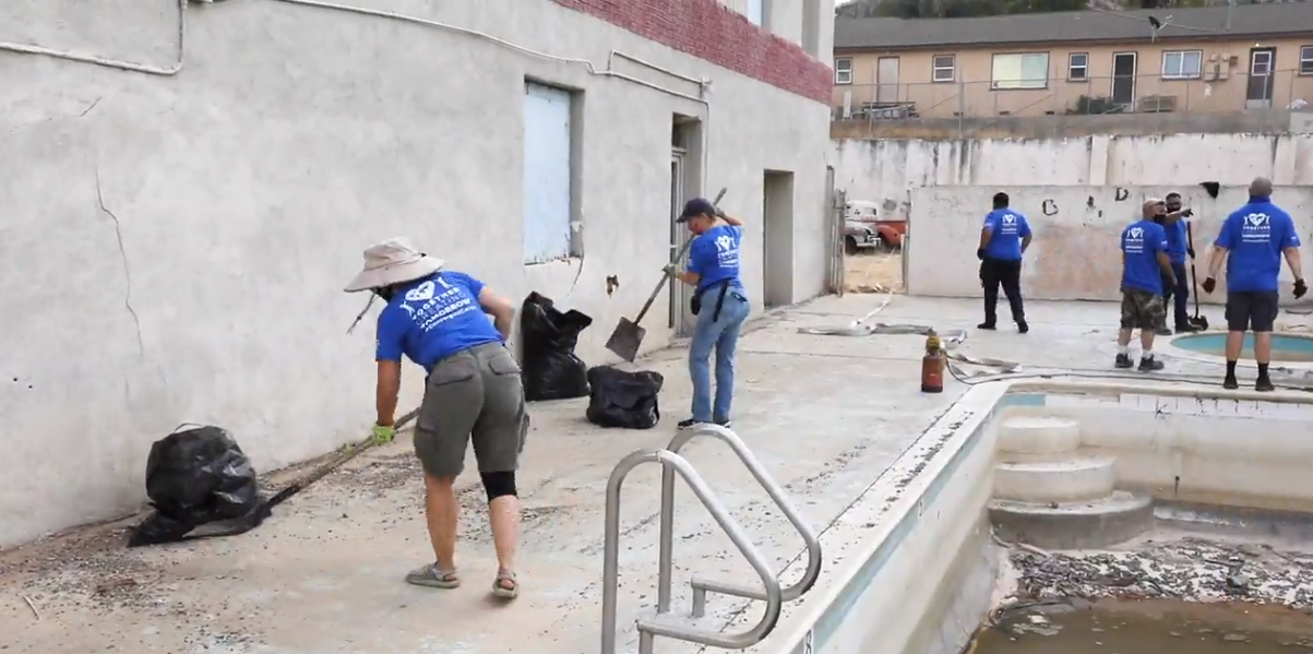 Colleagues cleaning up debris