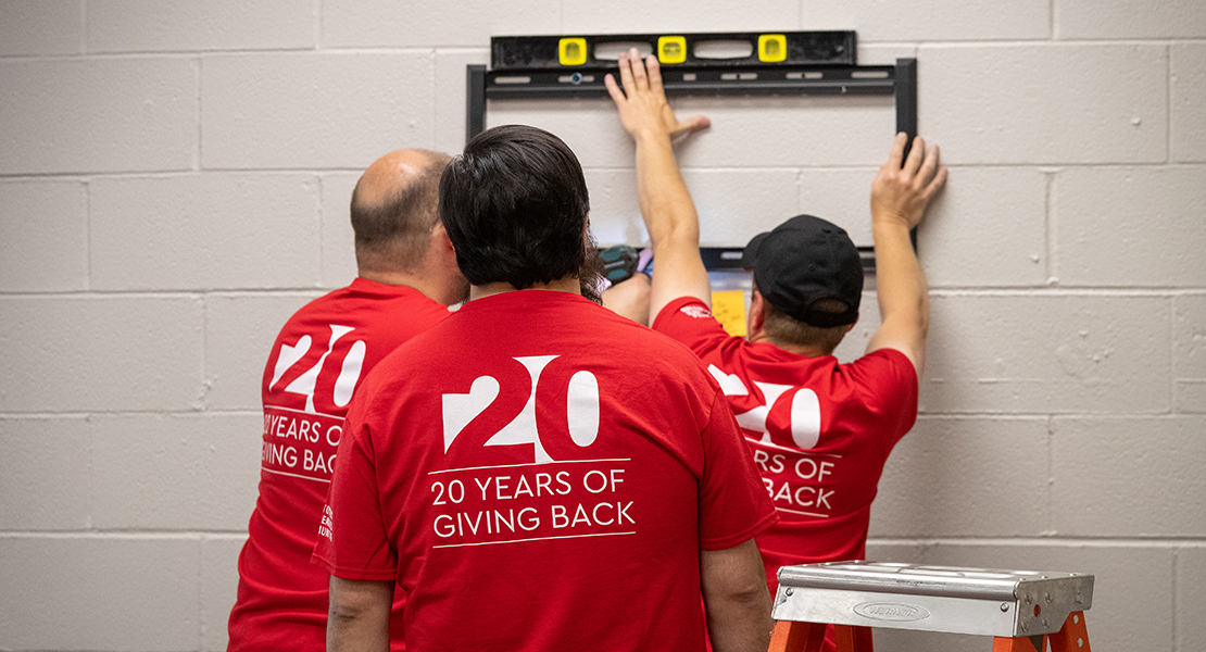 colleagues mounting a screen