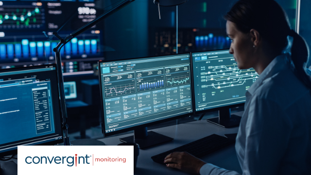 Female Software Engineer Working in a Modern Monitoring Office with Live Analysis Feed with Charts on a Big Digital Screen. Monitoring Room Big Data Scientists and Managers Sit in Front of Computers.