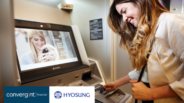 Women entering card into ITM bank machine