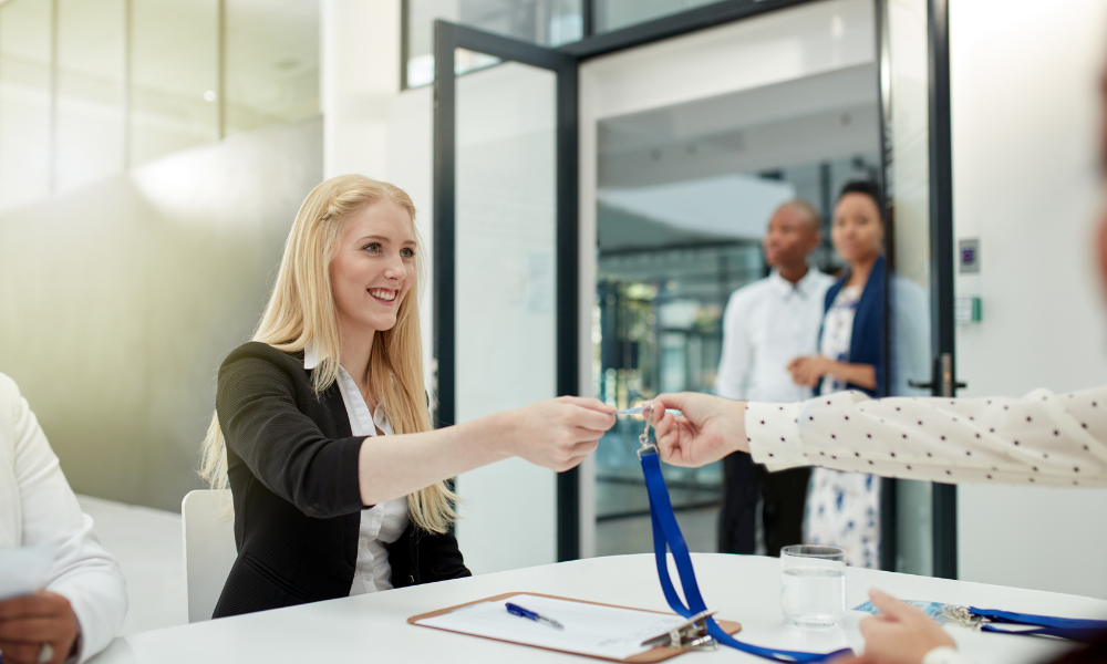 Access control card being handed to a woman