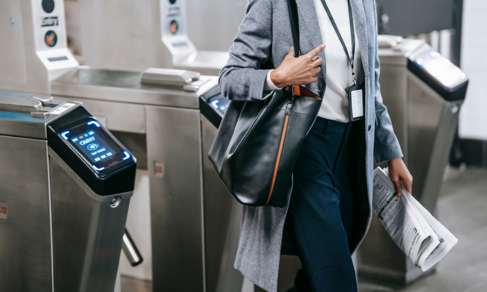 person walking through turnstile