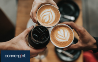 Three individuals holding cups of coffee