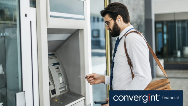 Man inserting bank card into atm machine