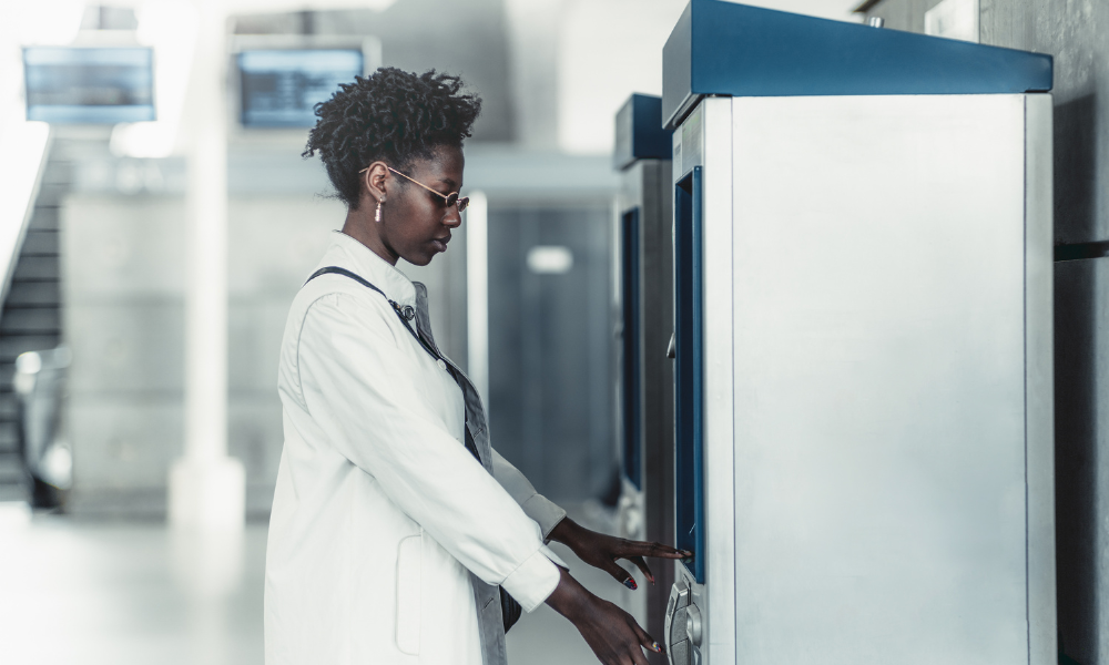 Woman standing at financial machine