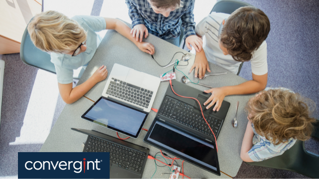 group of kids working on laptops