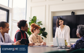 five women working around a conference table