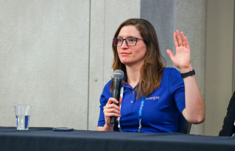 Woman raising her hand with microphone