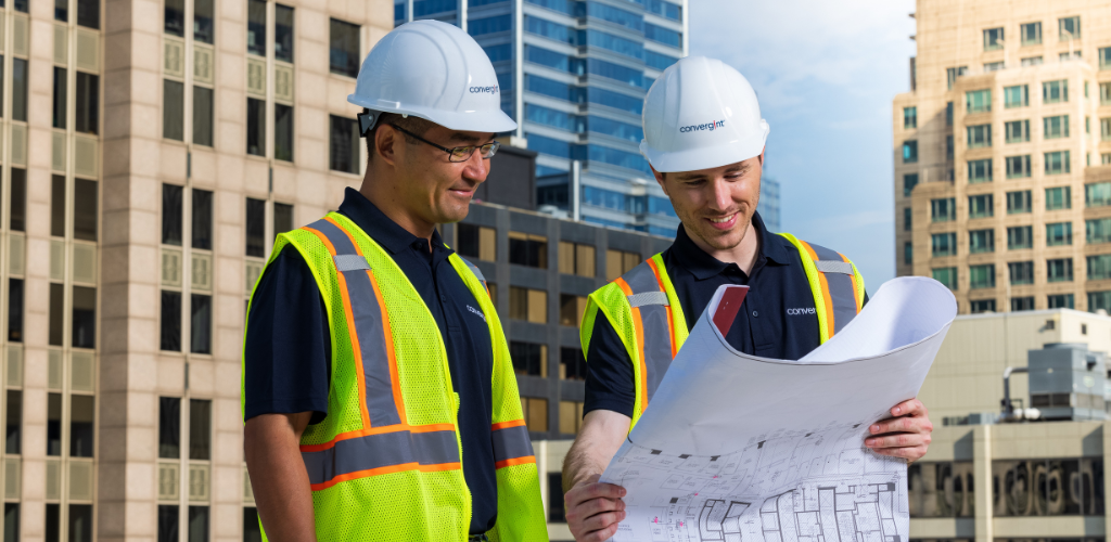 two people looking at blueprints