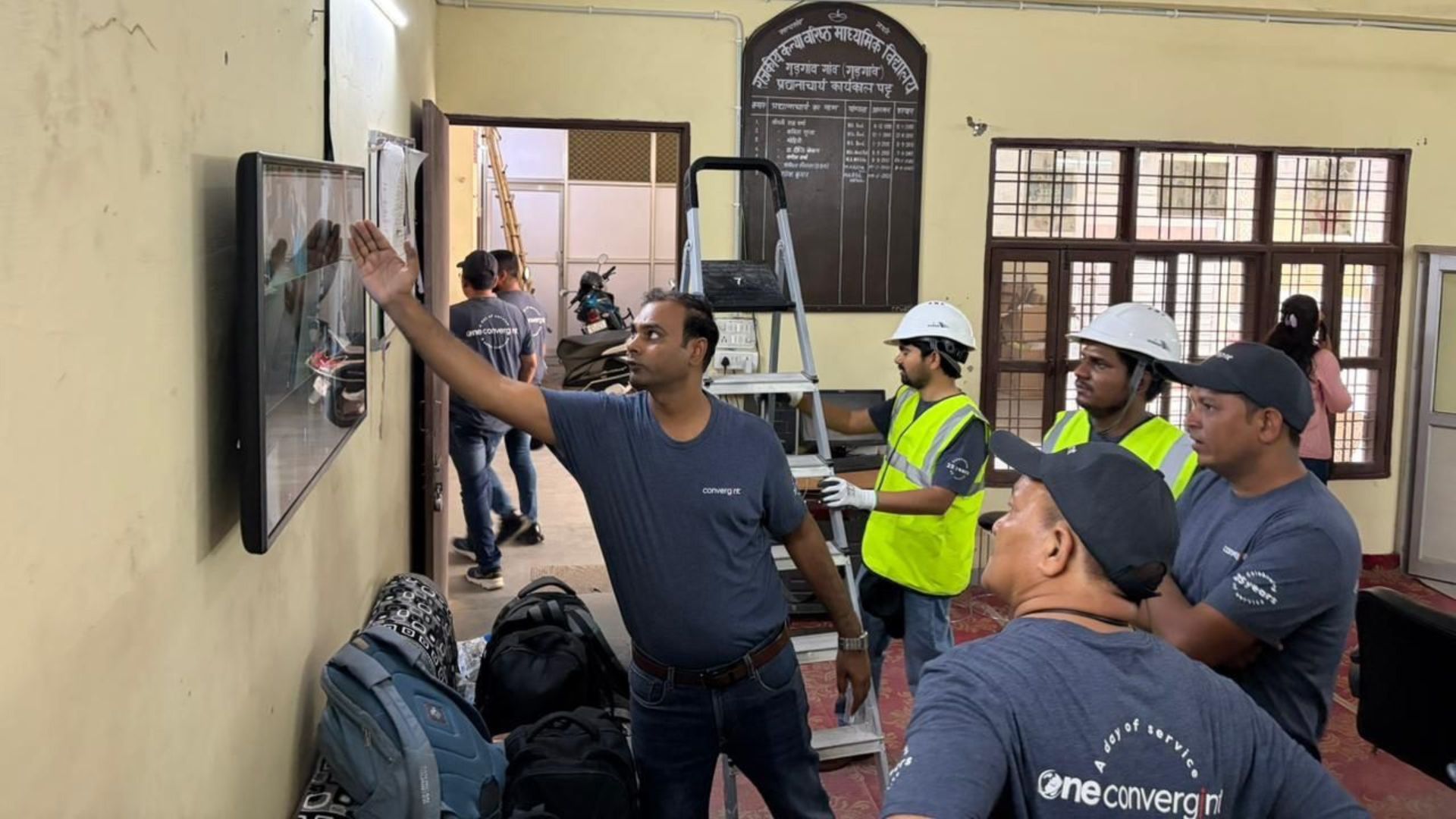 A colleague pointing at the screen while others learn
