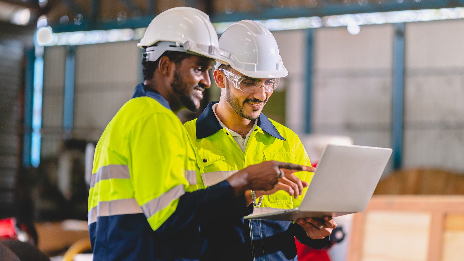 Workers looking at a laptop screen