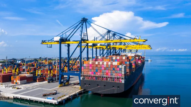 Contenedores de transporte que se están cargando en un barco en el puerto