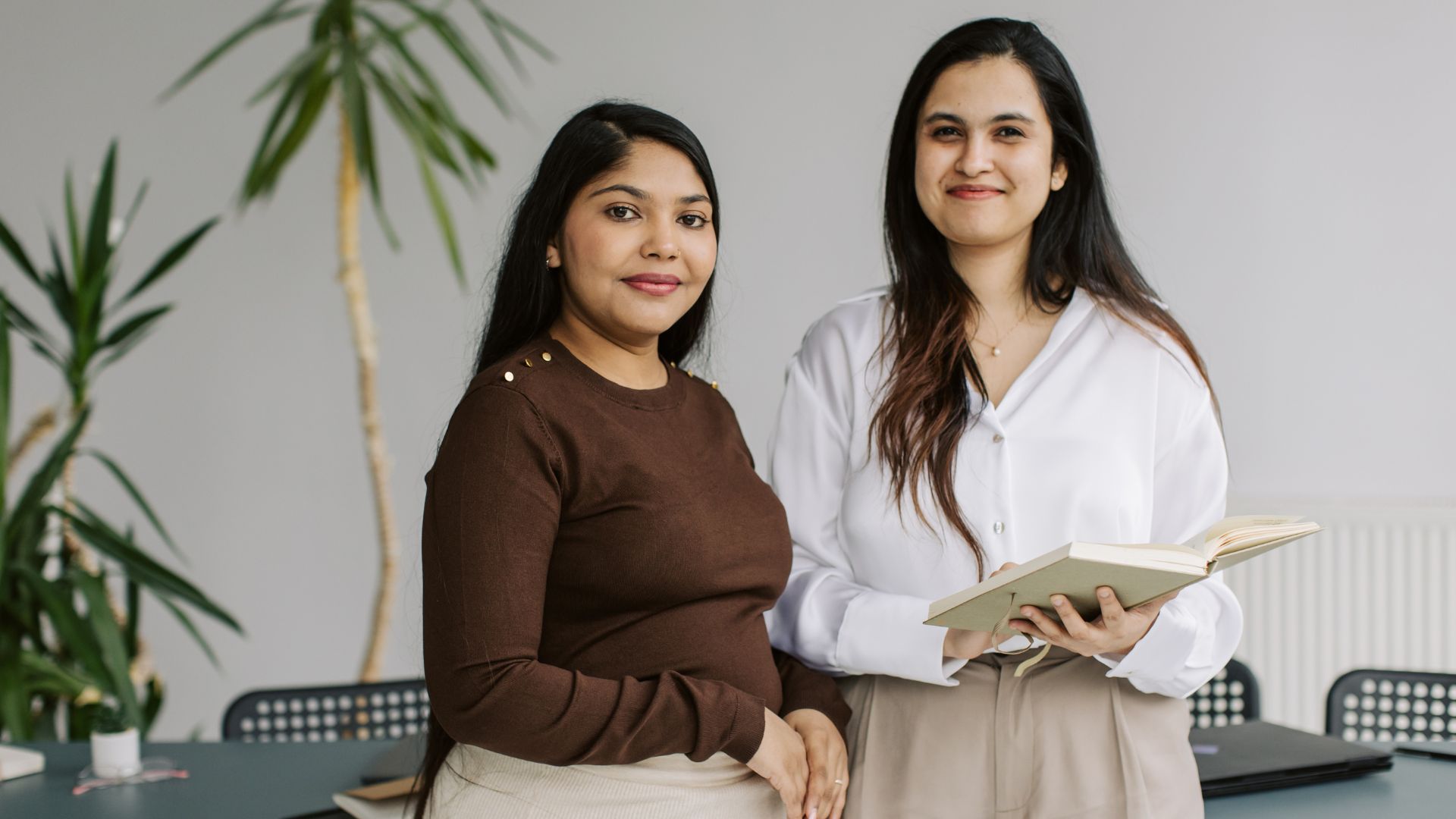 Two women looking at the camera smiling