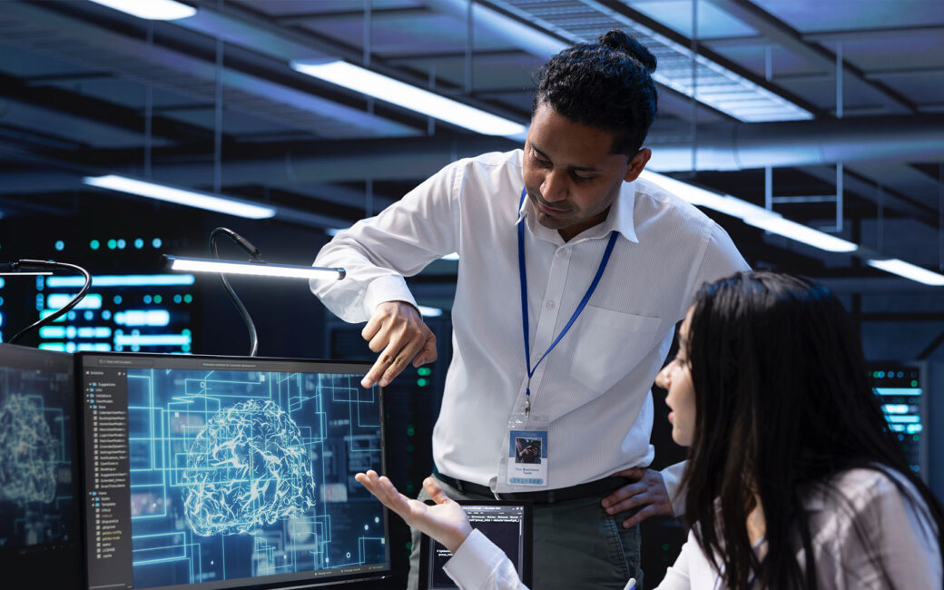 Teamworking colleagues in data center using PC to enable artificial intelligence