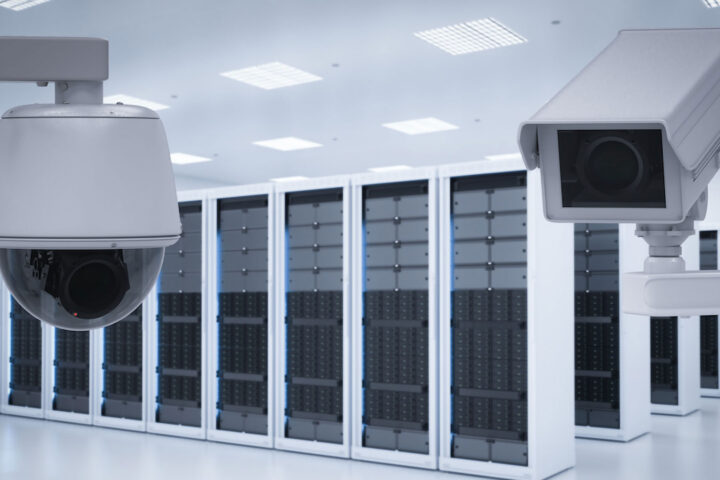 two white security cameras in an all-white server room